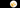 Two fried eggs on a white plate with French fries against a black background
